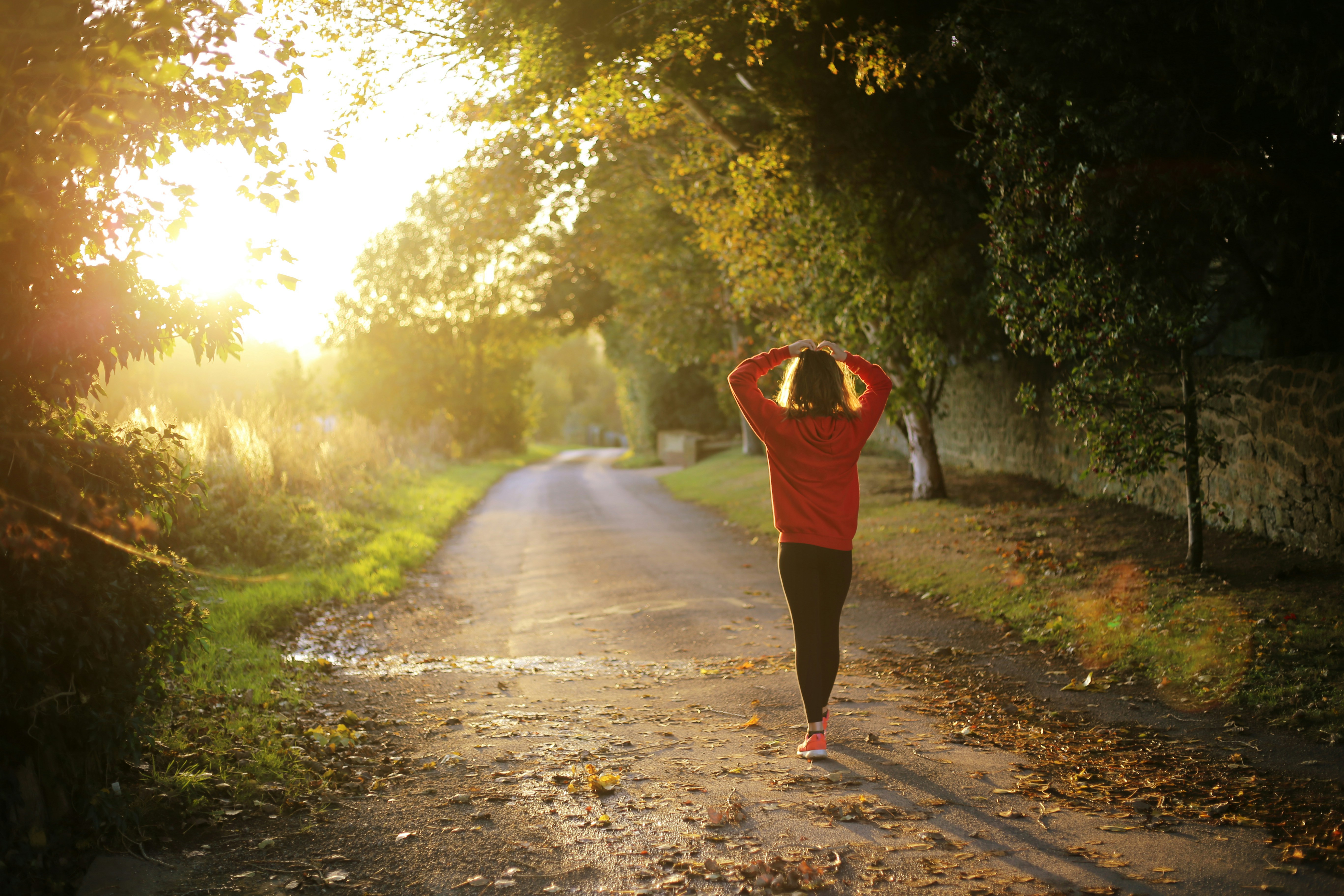 Woman walking outdoors encouraging balanced hormones Woman walking outdoors encouraging balanced hormones