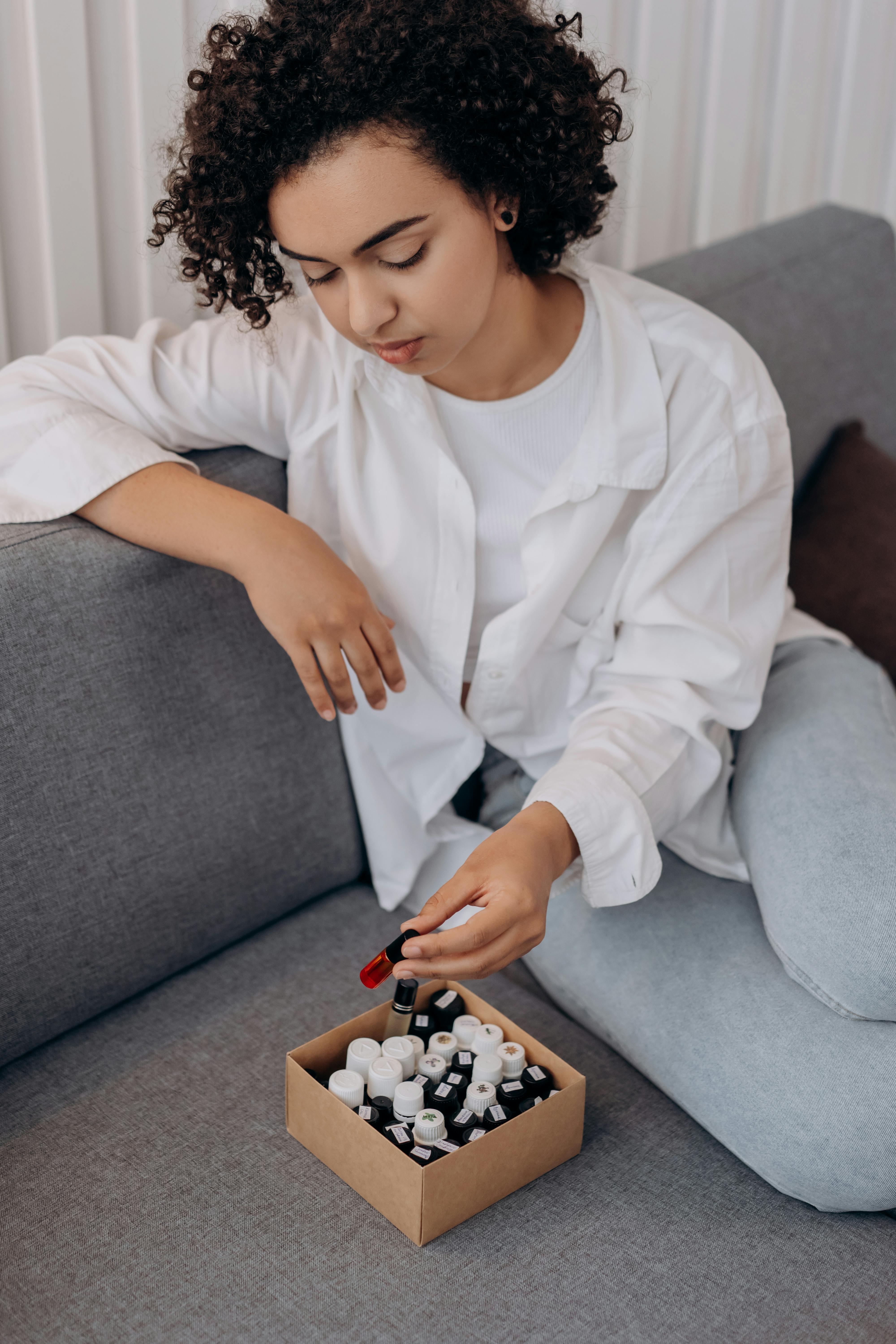 lady looking at her essential oil collection lady looking at her essential oil collection