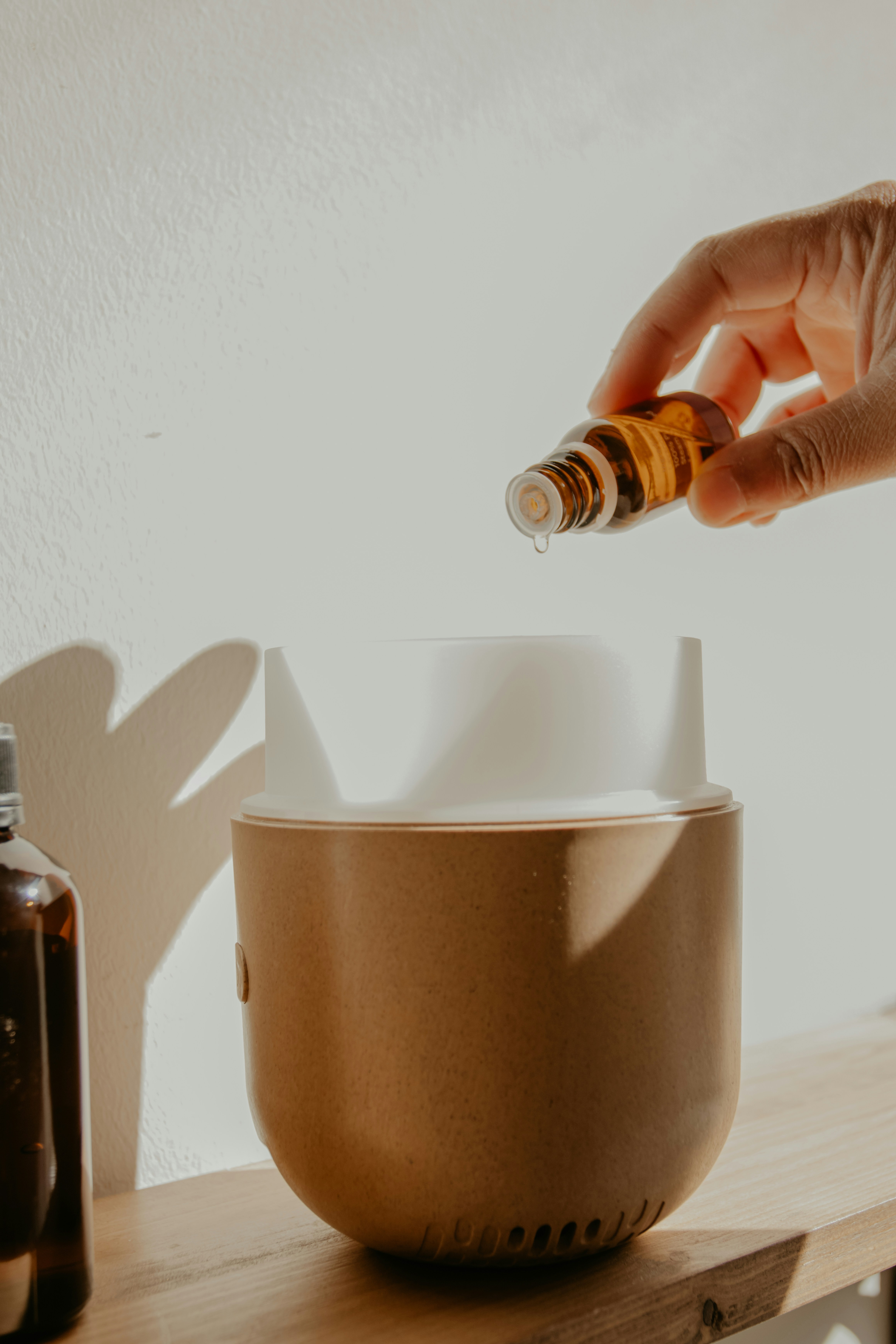 adding essential oil to diffuser