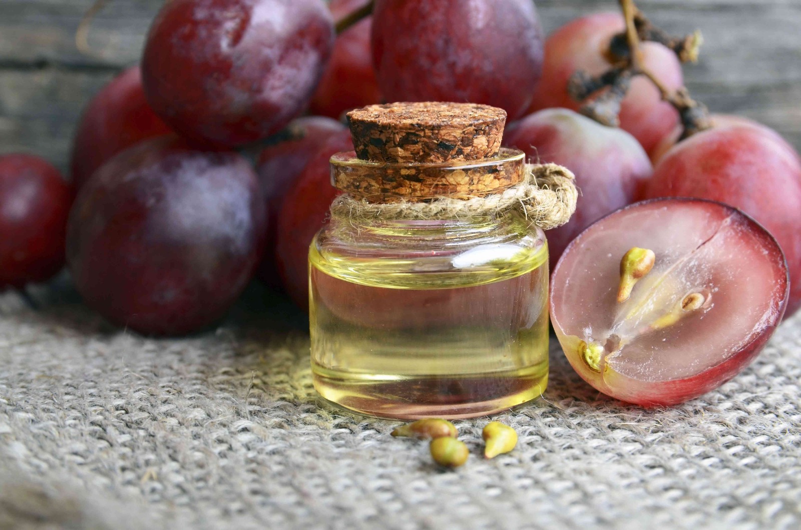grapeseed oil bottle with grapes on counter top