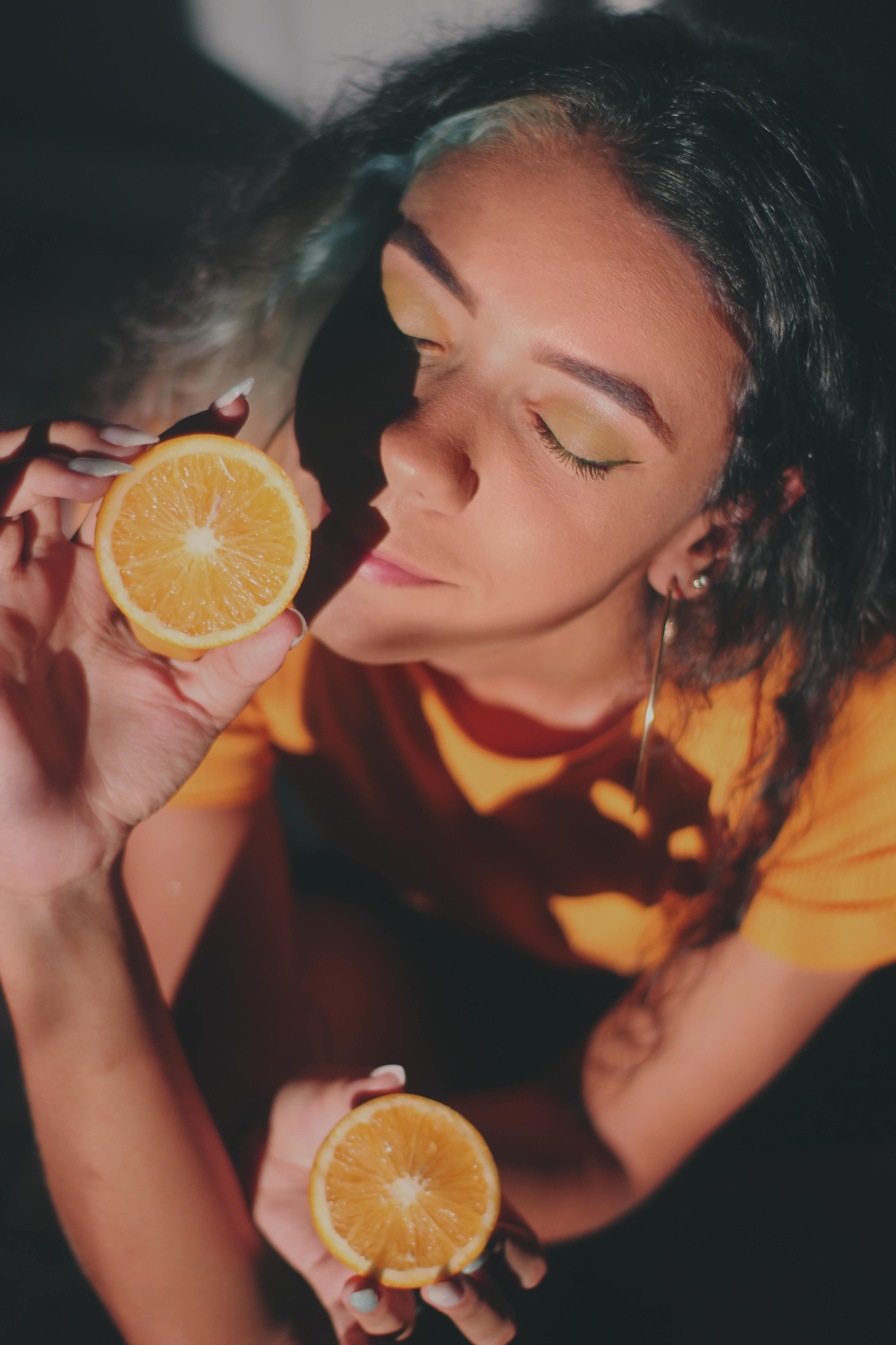 lady smelling oranges lady smelling oranges