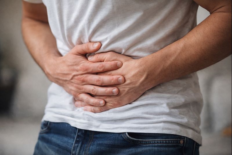 hands over abdomen with cramps