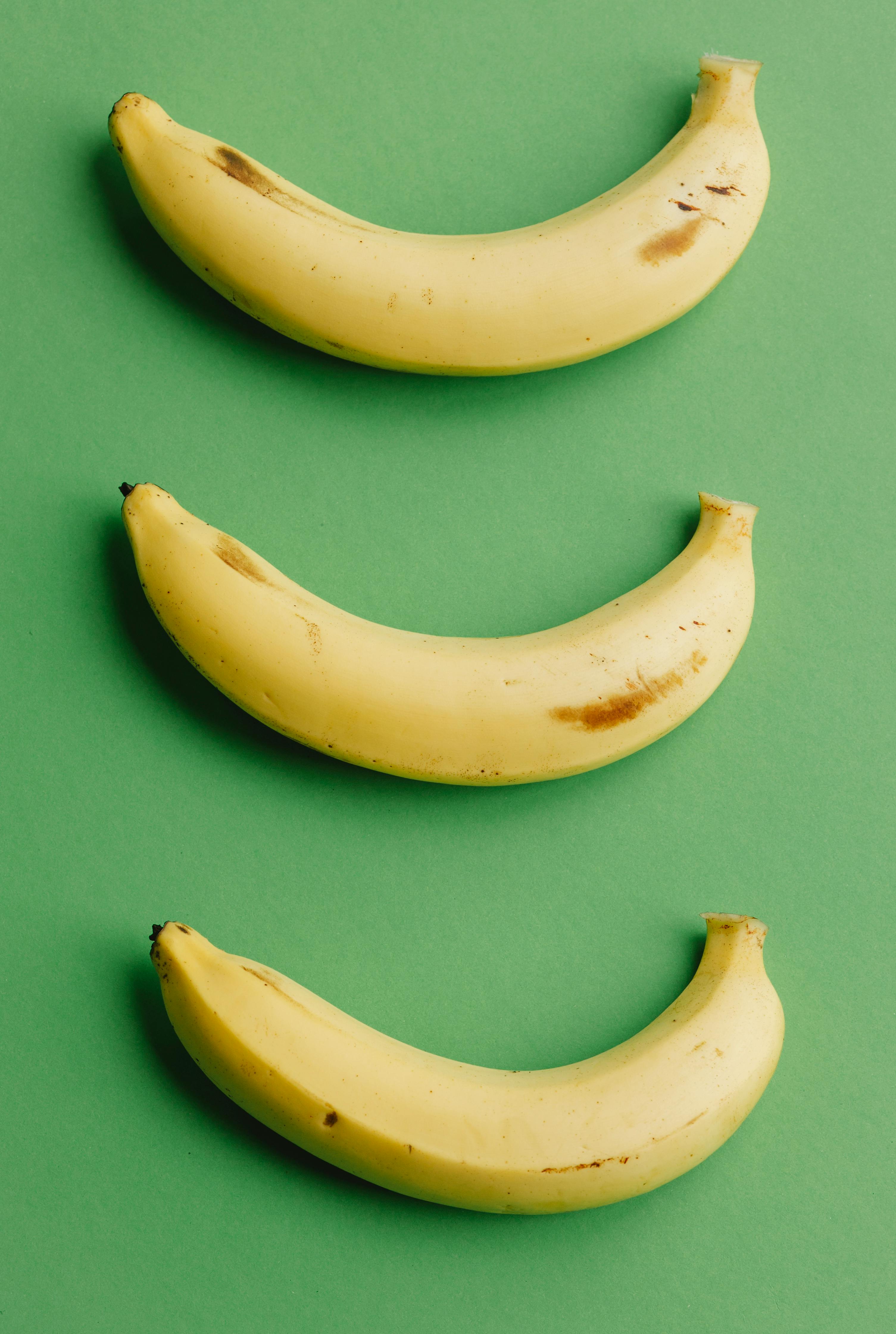 three unpeeled bananas