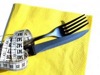 measuring tape wrapped around a knife and fork